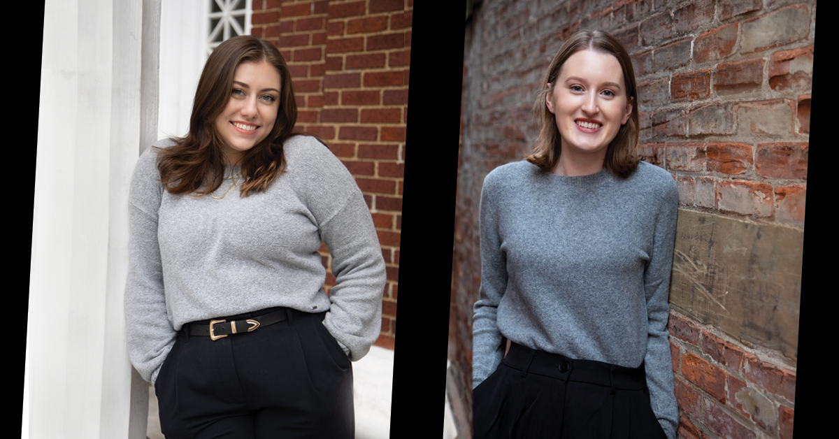 two women in grey sweaters leaning against brick walls